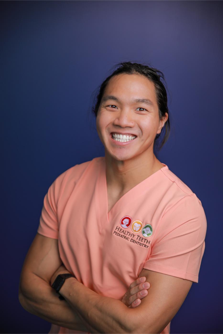 Dr James Bui pediatric dentist showing dental tools as a fun game to a happy child patient during a routine preventative visit