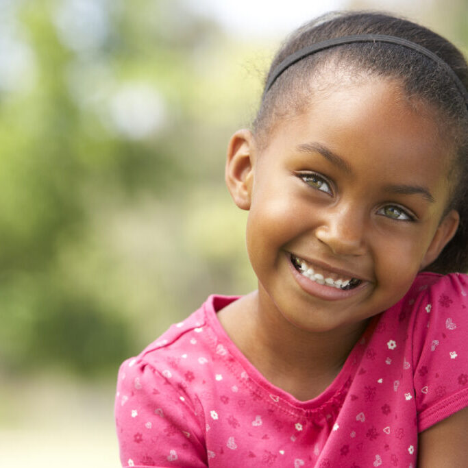 A happy young patient smiling after an easy preventative cleaning session at our Sugar Land pediatric dentist office