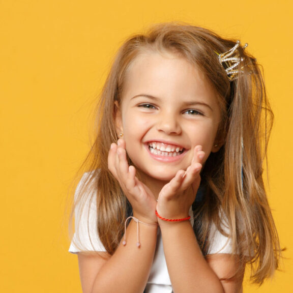 Smiling little girl ready for safe pediatric dental x-rays at Healthy Teeth Pediatric Dentistry in Sugar Land, TX