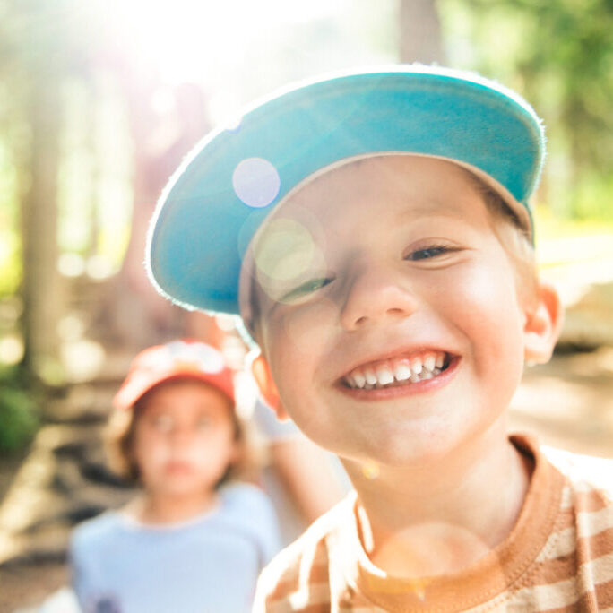 Happy young camper smiling after pediatric sedation dentistry at Healthy Teeth Pediatric Dentistry in Sugar Land, TX